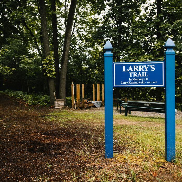 A scenic walking trail at Rose Hill Center, winding through a wooded area