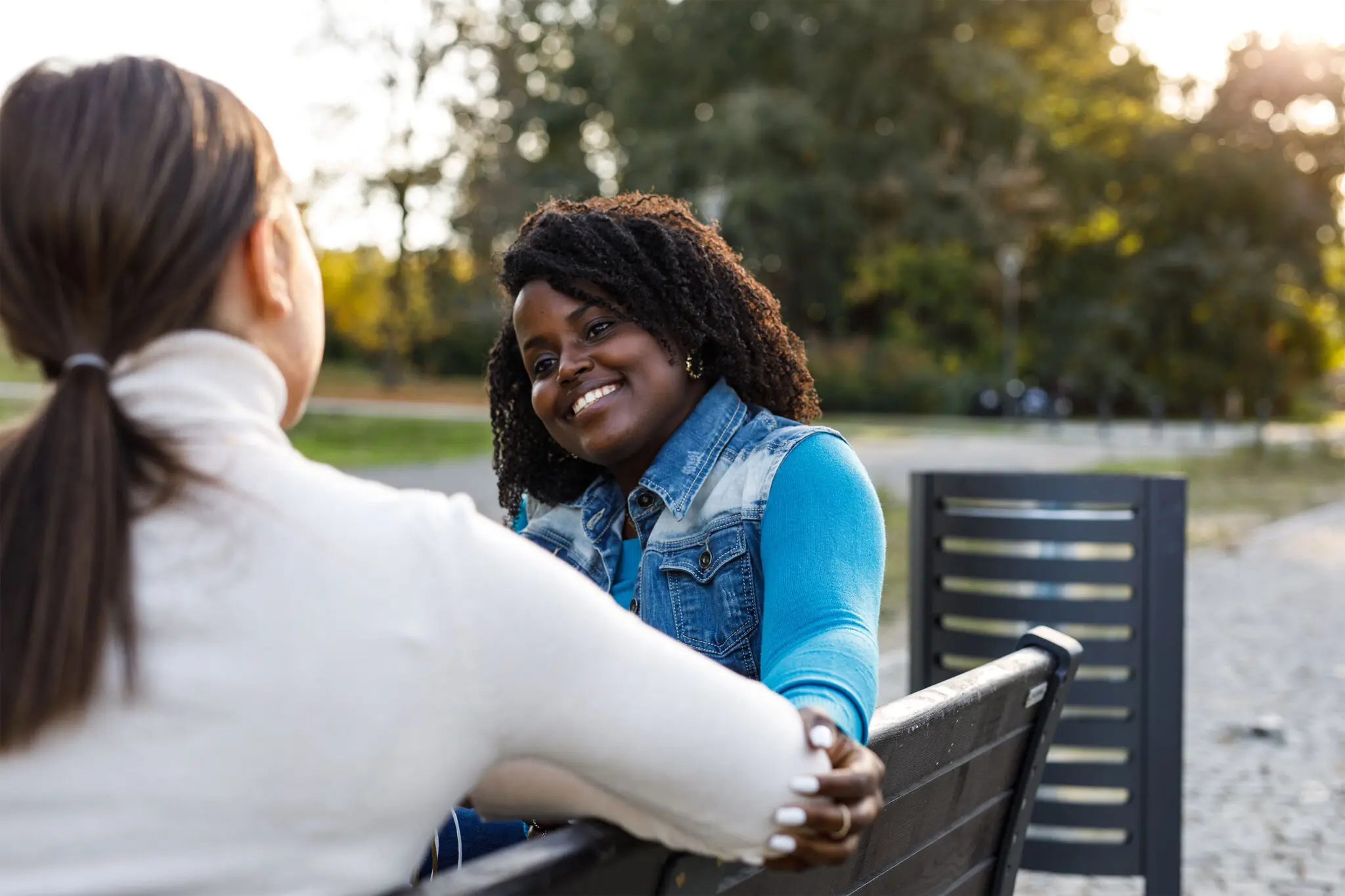 Two women siting outside, enjoying the fresh air, surrounded by natural beauty