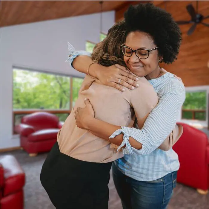 Two people in a warm embrace, illustrating an inclusive atmosphere where friendships can flourish