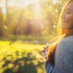 healthy woman in woods with sunrise photo