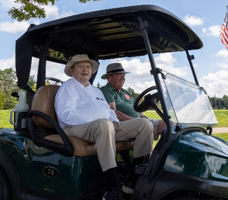 Dan Kelly riding golf cart photo